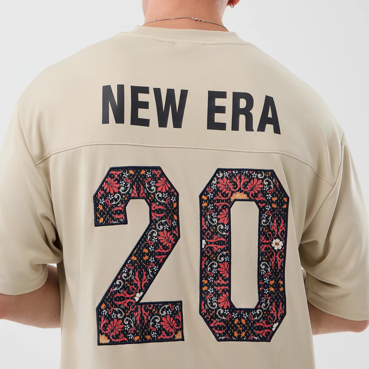 The Male model is wearing New Era Mesh Infill Light Beige Oversized T-Shirt 7