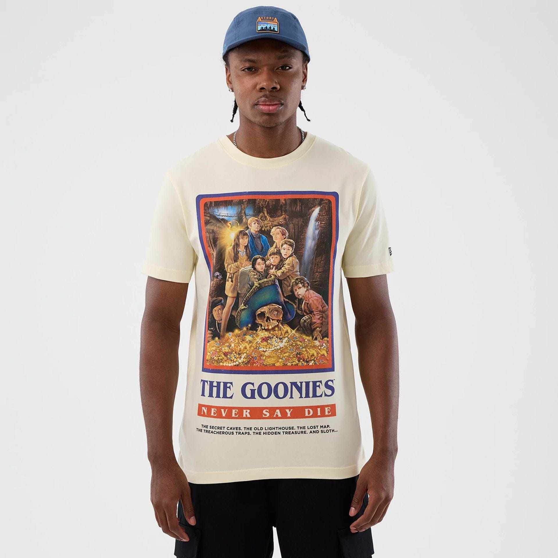 The model is wearing this Movie Poster The Goonies T-Shirt in Cream. 1