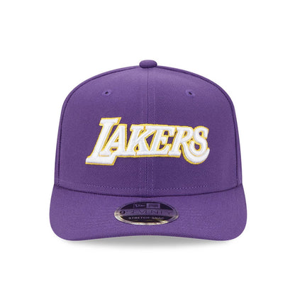 LA Lakers NBA Statement Purple New Era 9SEVENTY Stretch Snap Adjustable Cap, front view showing the raised Lakers logo in white and gold embroidery on the centre of the front panel, with a matching purple visor featuring a 9SEVENTY size sticker.