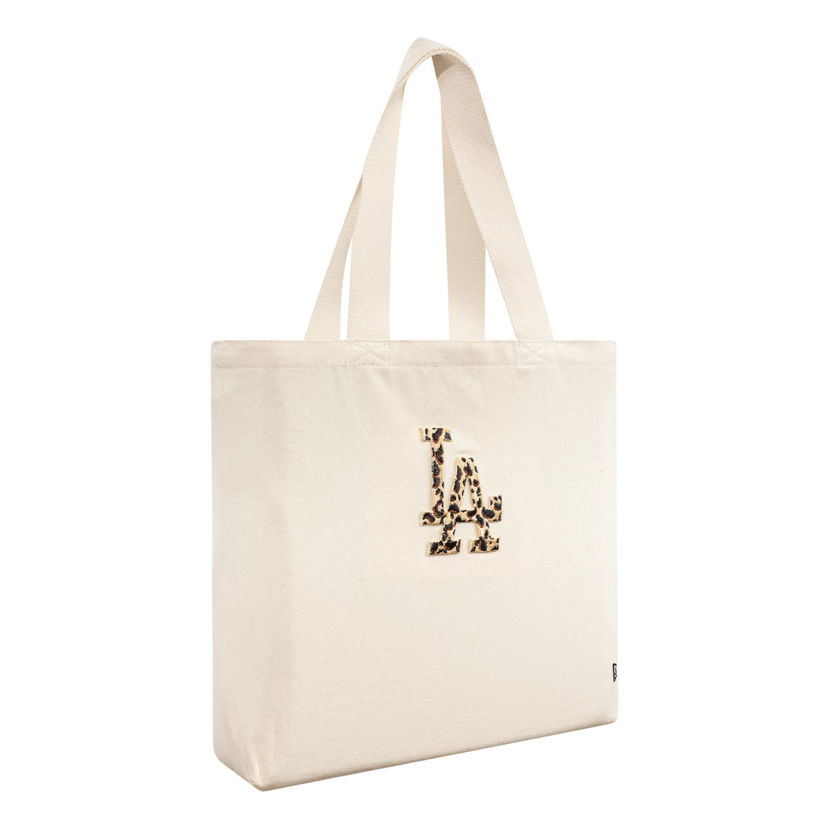 New Era LA Dodgers MLB Animal Infill Cream Tote Bag, three-quarter view showing the cream tote with a large animal print embroidered LA logo on the front and two cream shoulder straps extending from the top.