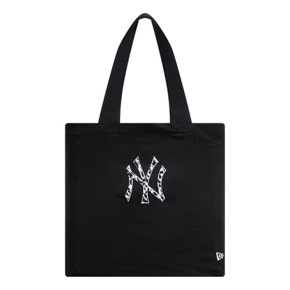 New Era New York Yankees MLB Animal Infill Black Tote Bag, front view showing the large animal print NY logo embroidered in white at the centre of the bag and a small white debossed New Era logo near the bottom corner.