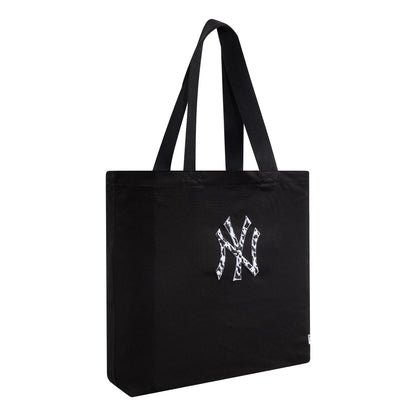 New Era New York Yankees MLB Animal Infill Black Tote Bag, side view displaying the black structure with twin handles and an embroidered New York Yankees logo featuring an animal print pattern in the centre.