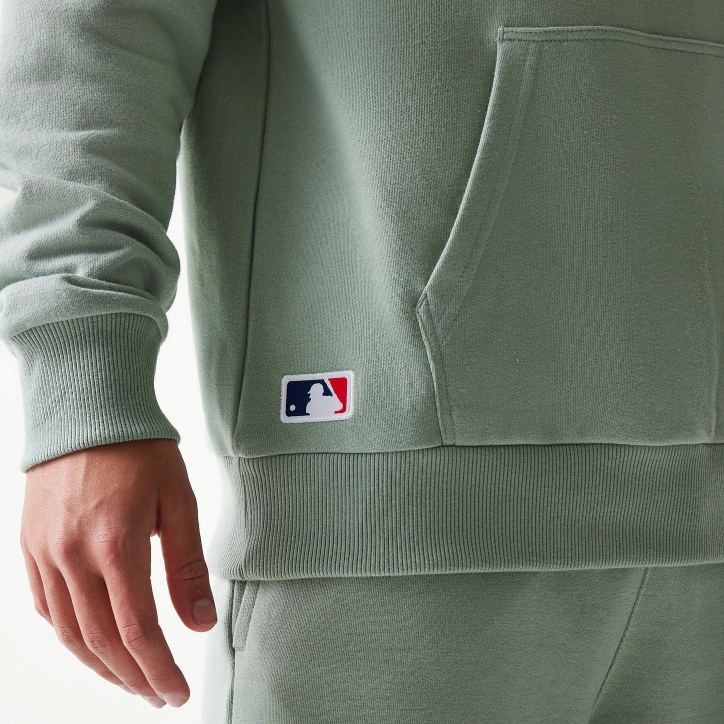 The model is wearing this MLB League Essential Midi LA Dodgers Oversized Pullover Hoodie in pastel green. 4
