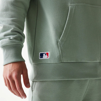 The model is wearing this MLB League Essential Midi LA Dodgers Oversized Pullover Hoodie in pastel green. 4