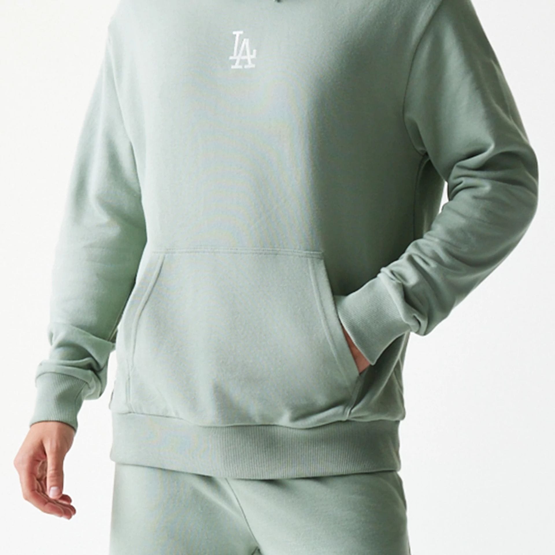 The model is wearing this MLB League Essential Midi LA Dodgers Oversized Pullover Hoodie in pastel green. 6
