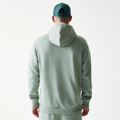 The model is wearing this MLB League Essential Midi LA Dodgers Oversized Pullover Hoodie in pastel green. 2