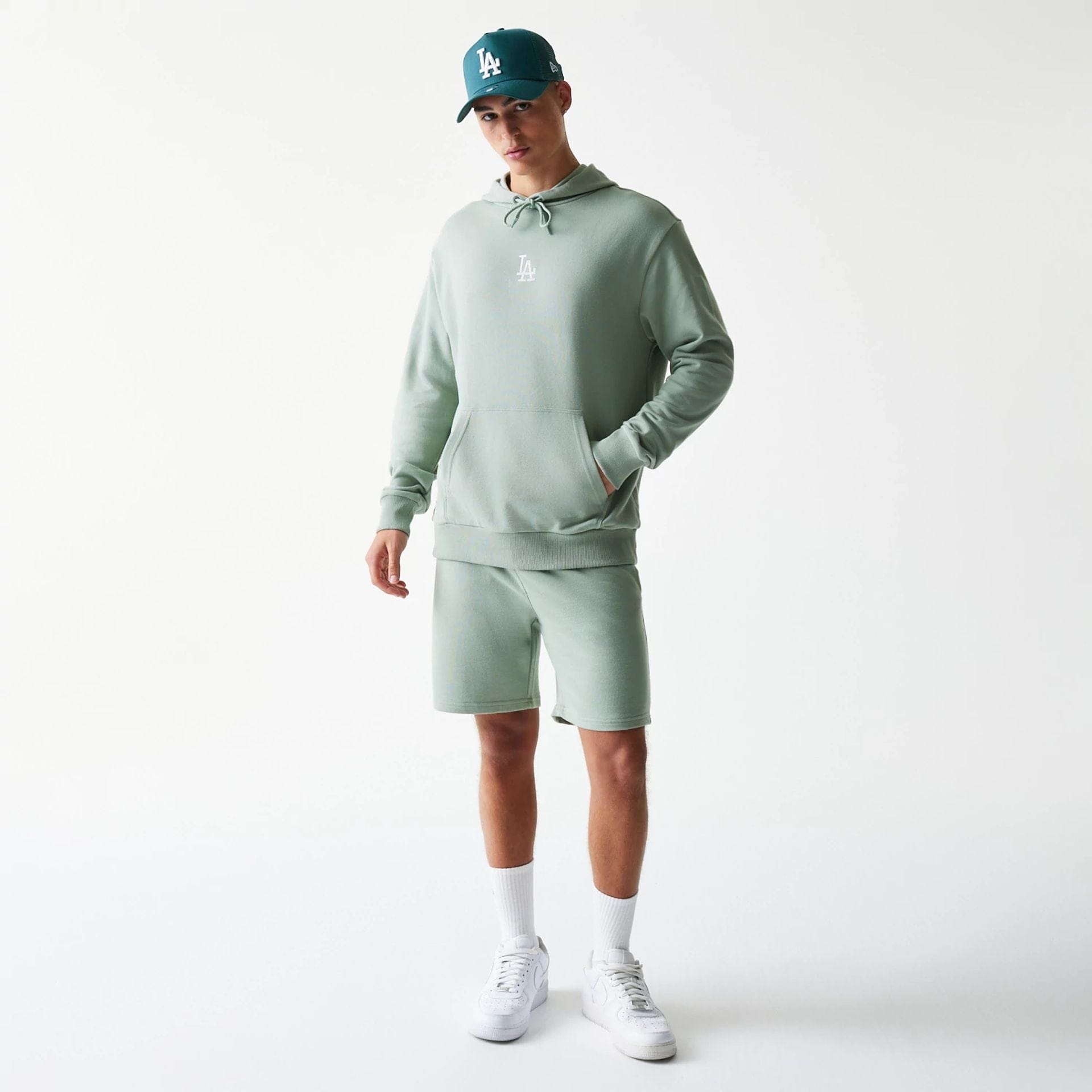 The model is wearing this MLB League Essential Midi LA Dodgers Oversized Pullover Hoodie in pastel green. 8