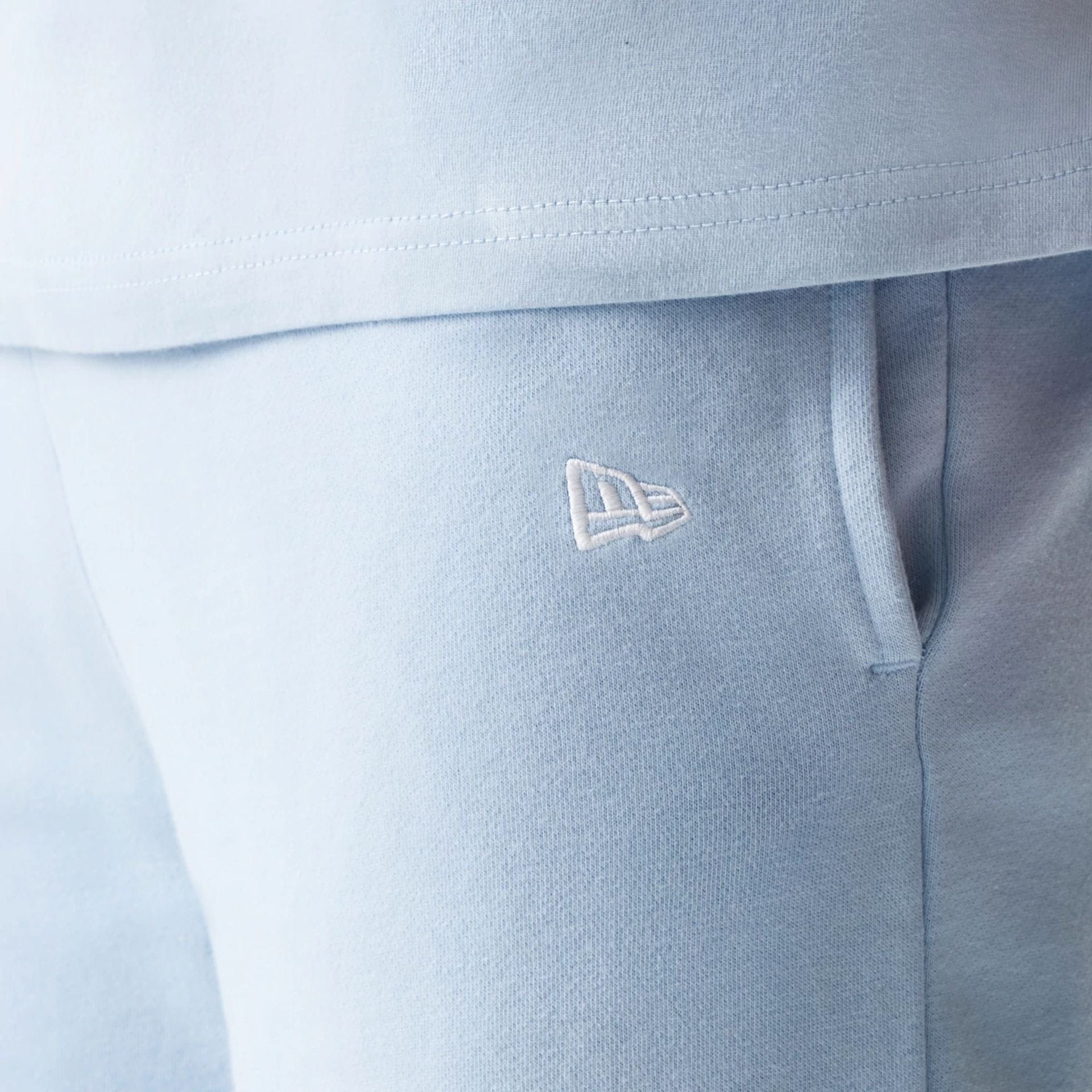 The model is wearing this MLB League Essential Midi New York Yankees Shorts in pastel blue. 5