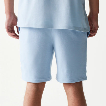 The model is wearing this MLB League Essential Midi New York Yankees Shorts in pastel blue. 7