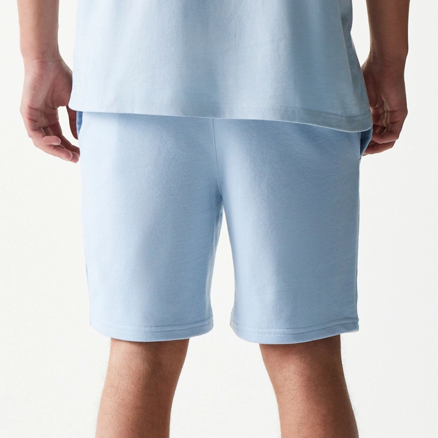 The model is wearing this MLB League Essential Midi New York Yankees Shorts in pastel blue. 7