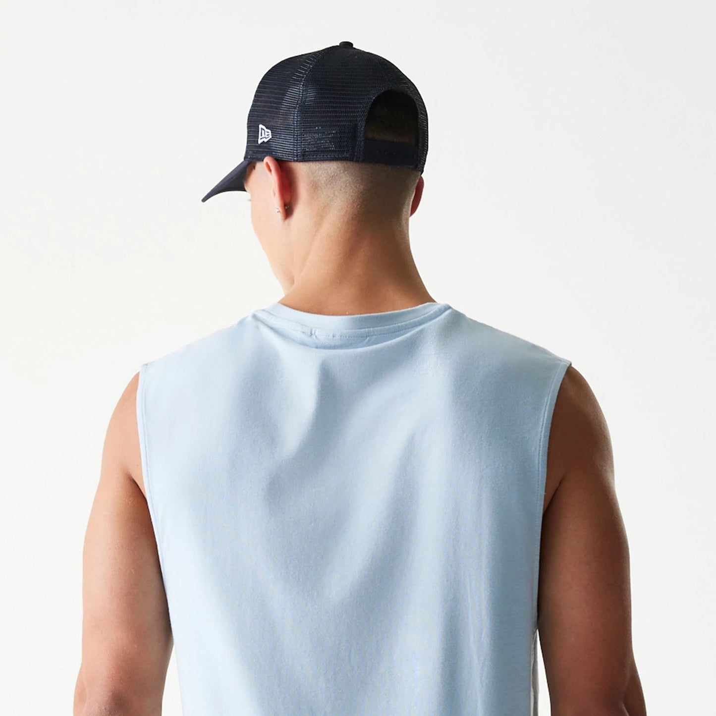 The model is wearing this MLB League Essential New York Yankees Sleeveless T-Shirt in pastel blue. 7