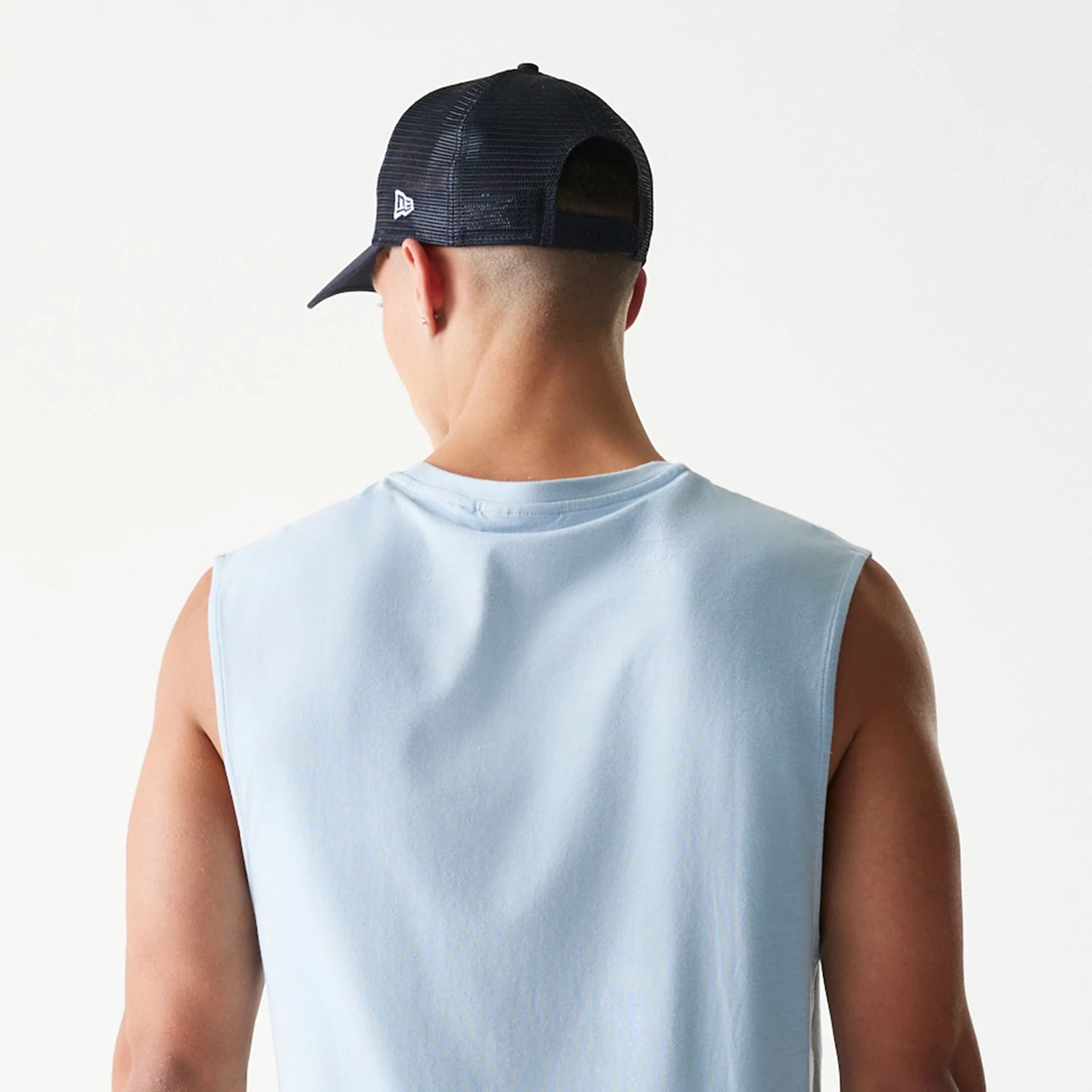 The model is wearing this MLB League Essential New York Yankees Sleeveless T-Shirt in pastel blue. 7