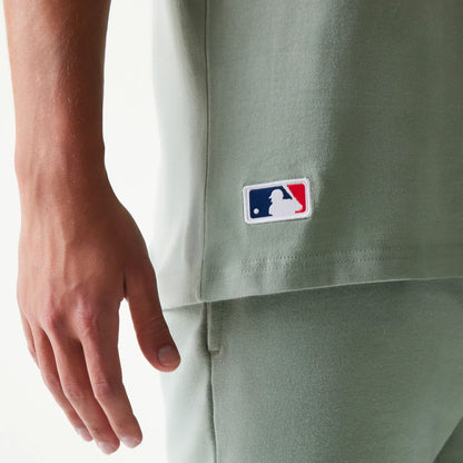 The model is wearing this MLB League Essential LA Dodgers Sleeveless T-Shirt in pastel green. 5