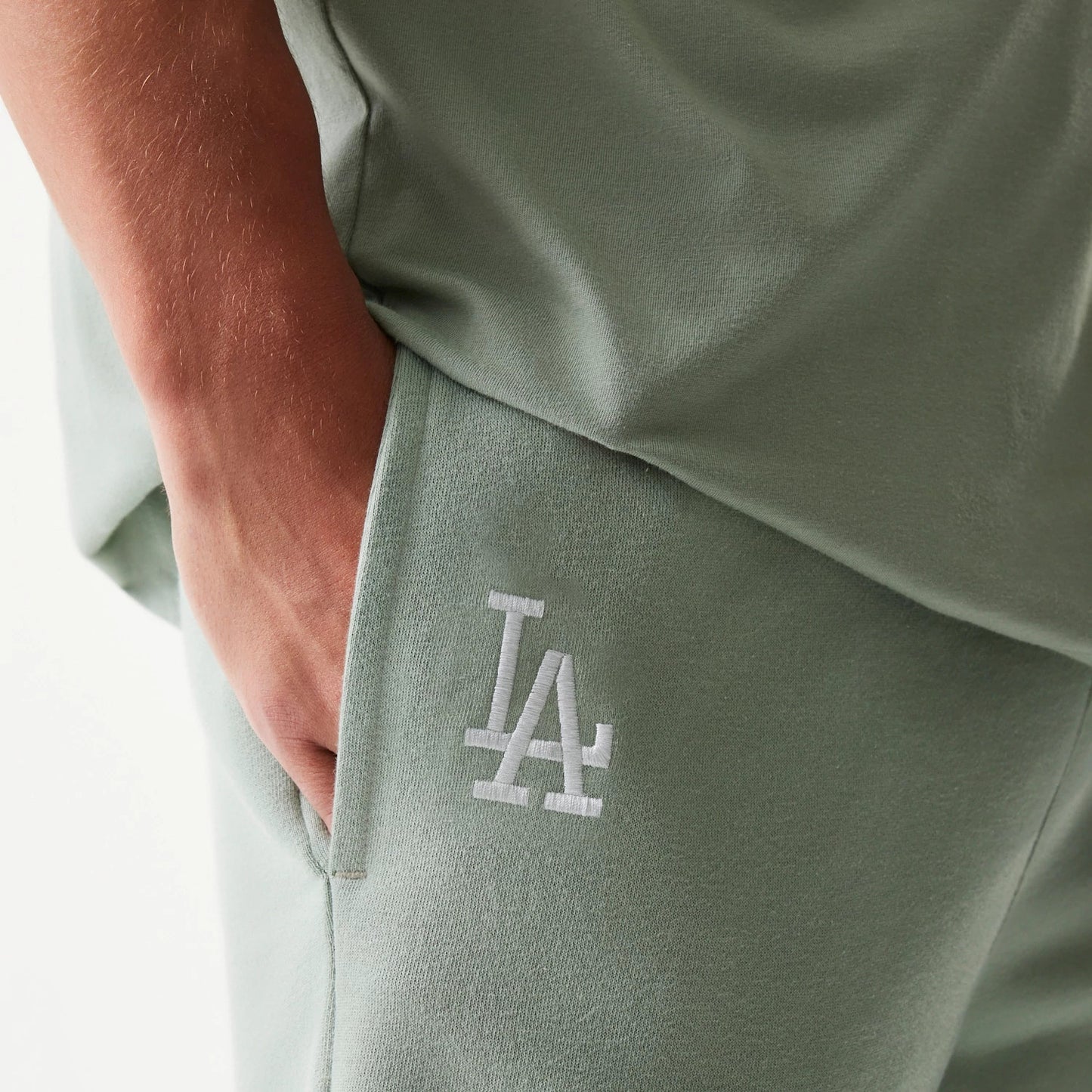 The model is wearing this MLB League Essential Midi LA Dodgers Shorts in pastel green. 4
