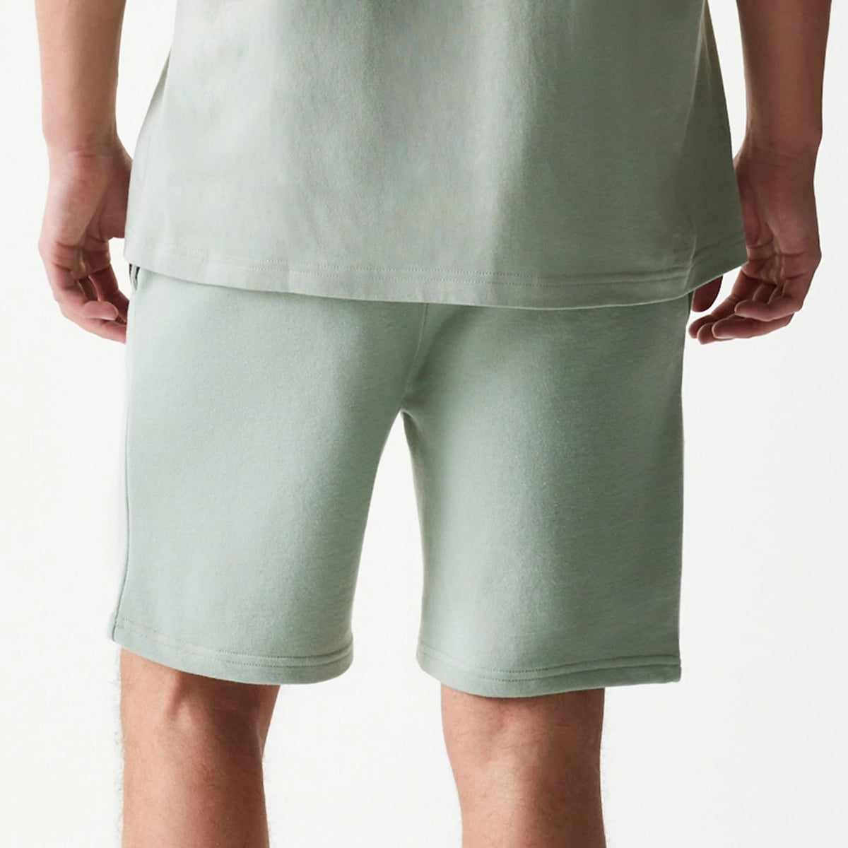The model is wearing this MLB League Essential Midi LA Dodgers Shorts in pastel green. 7