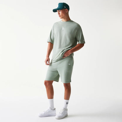 The model is wearing this MLB League Essential Midi LA Dodgers Shorts in pastel green. 8