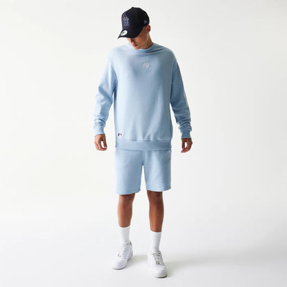 The model is wearing this MLB League Essential Midi New York Yankees Oversized Crew Neck Sweater in blue. 8
