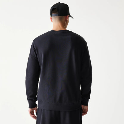 The model is wearing this NBA League Essential Chicago Bulls Oversized Crew Neck Sweater in black. 2