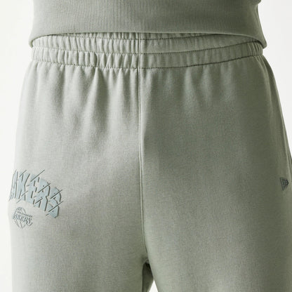 New Era LA Lakers NBA Pastel Green Straight Leg Joggers, rear view showing the raised Lakers logo on the left leg and a New Era flag logo on the right side, with an elasticated waistband and fabric finish.