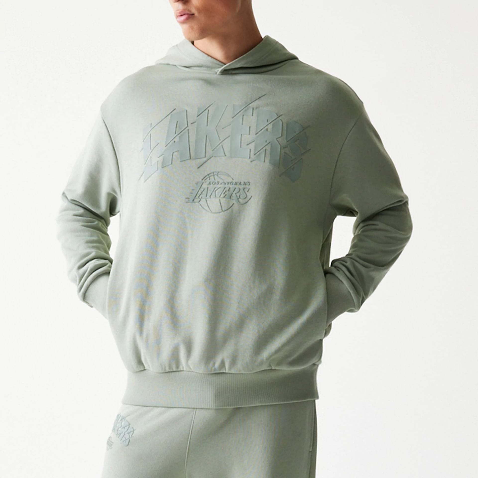 The model is wearing this NBA LA Lakers Oversized Pullover Hoodie in pastel green. 3