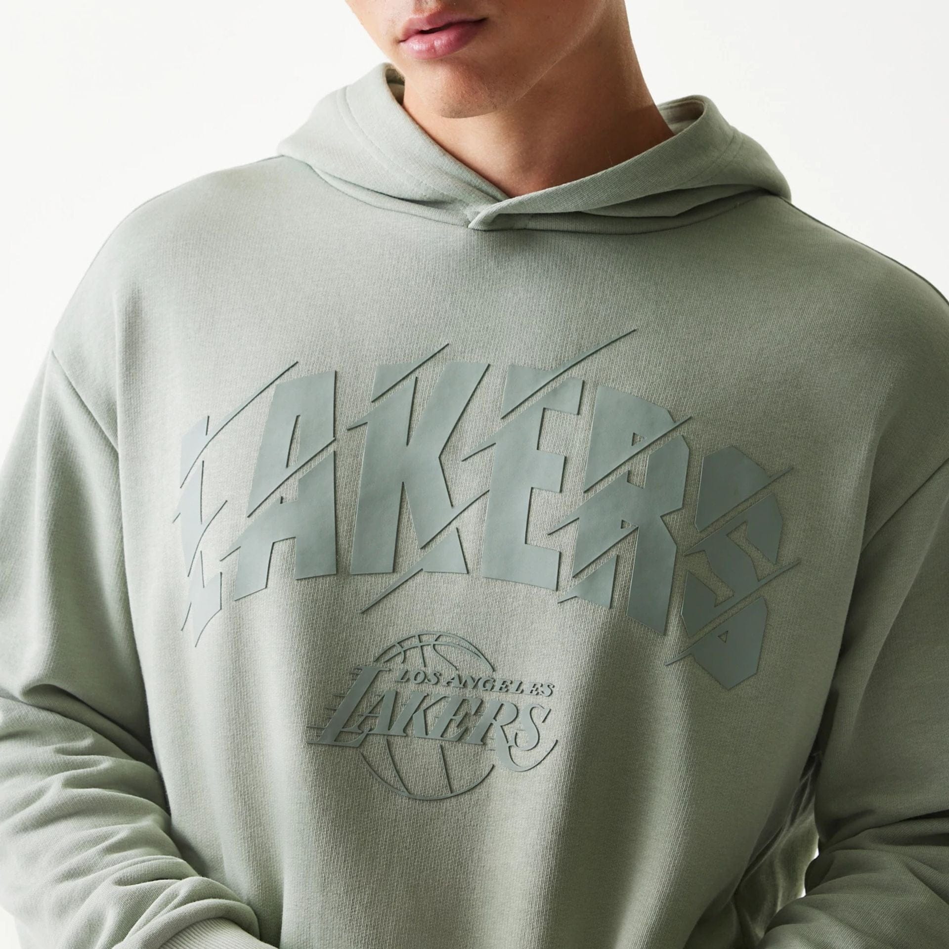 The model is wearing this NBA LA Lakers Oversized Pullover Hoodie in pastel green. 4