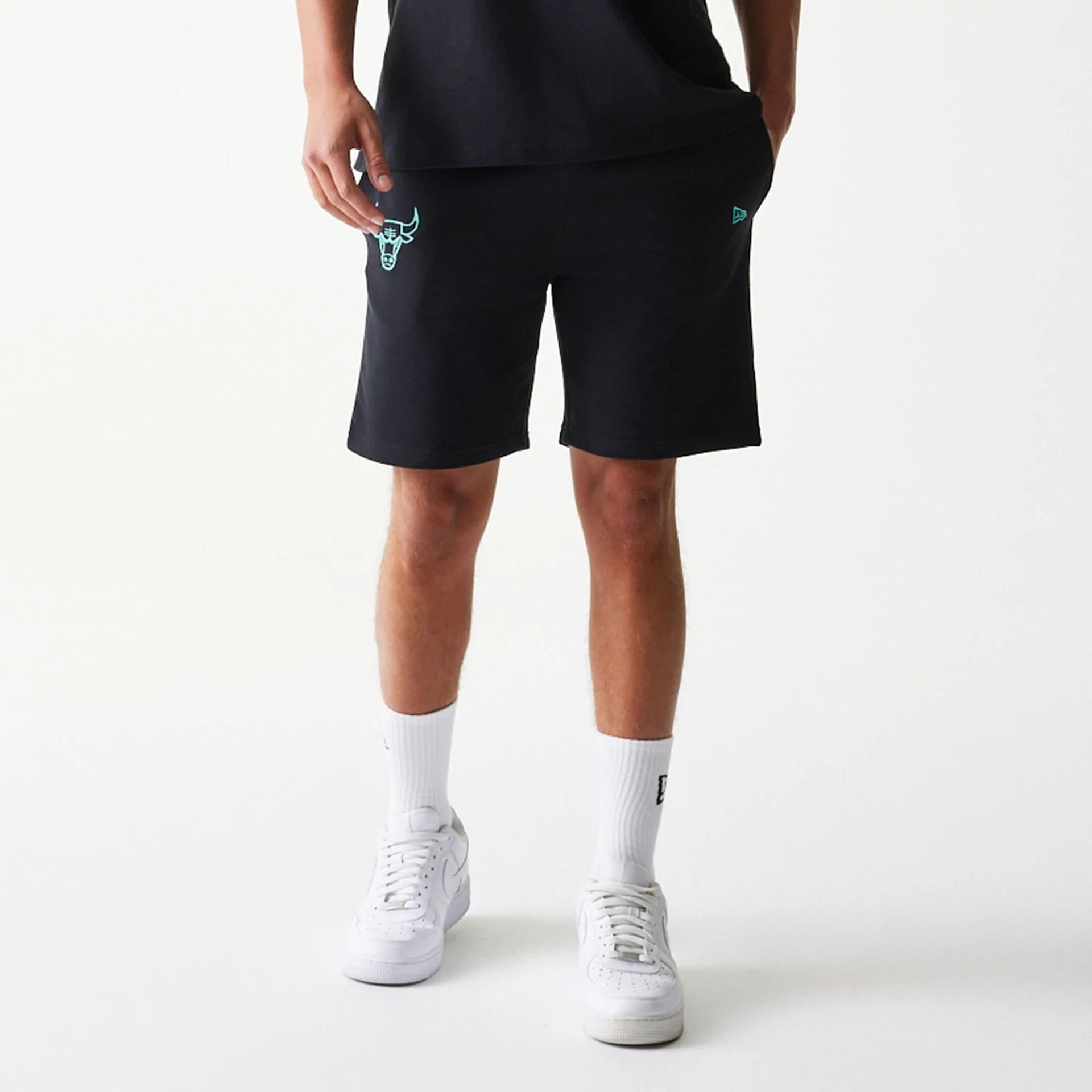 The model is wearing this NBA League Essential Chicago Bulls Shorts in black. 1