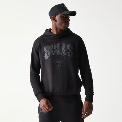 The model is wearing this NBA Chicago Bulls Oversized Pullover Hoodie in black. 3