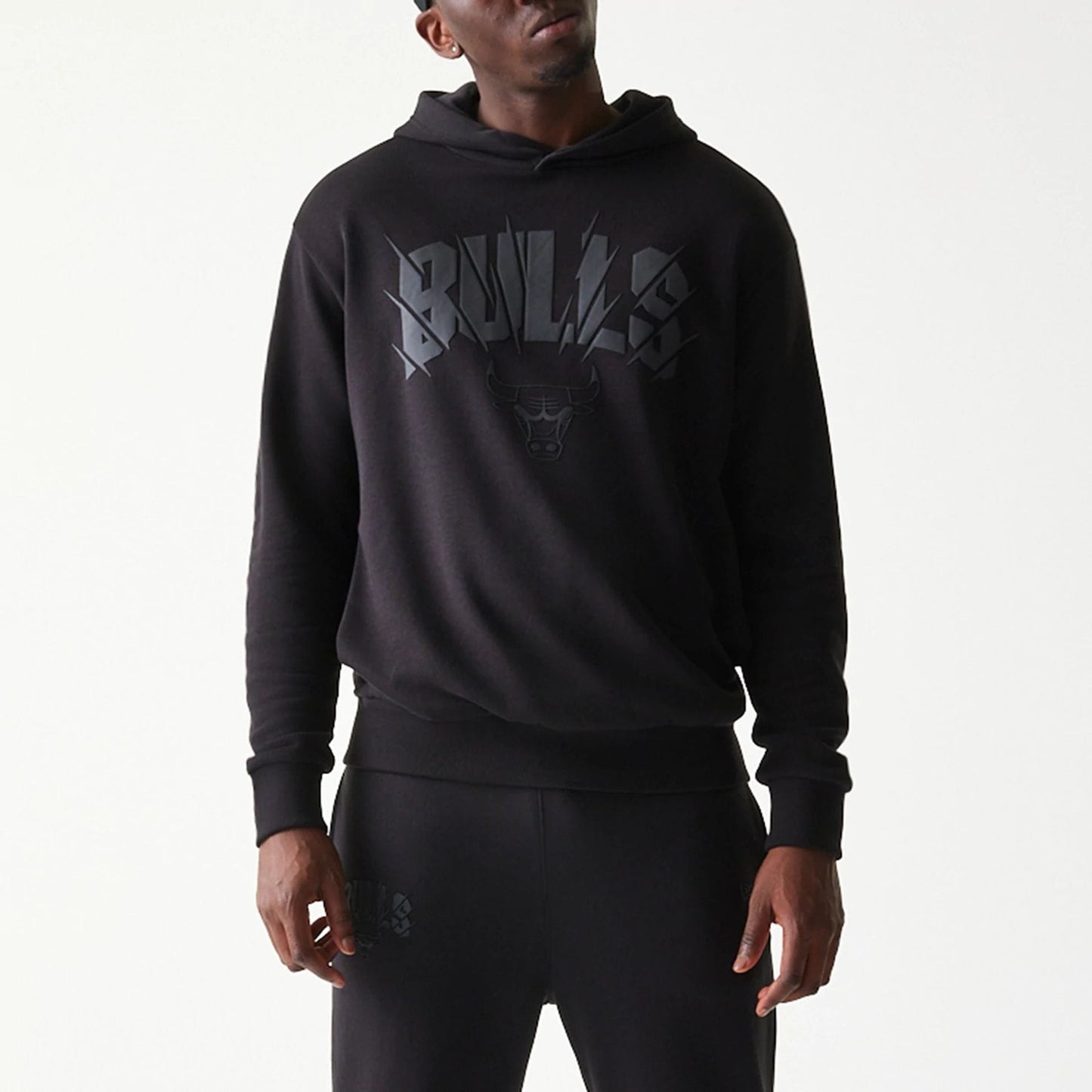 The model is wearing this NBA Chicago Bulls Oversized Pullover Hoodie in black. 5