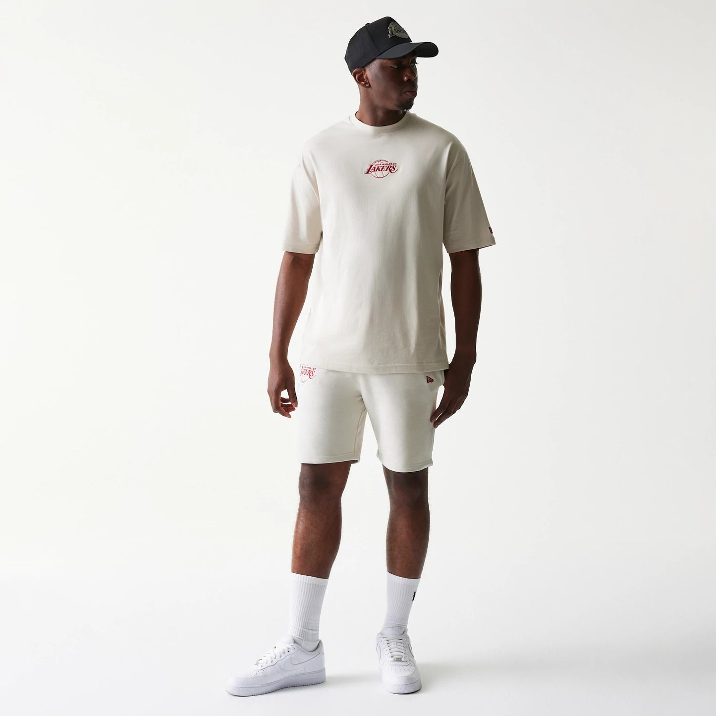 The model is wearing this NBA League Essential LA Lakers Shorts in cream. 7