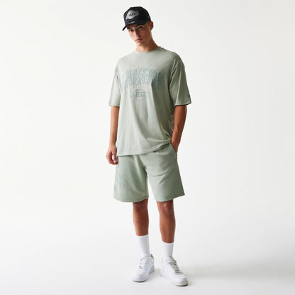 The model is wearing this NBA LA Lakers Oversized T-Shirt in pastel green. 8