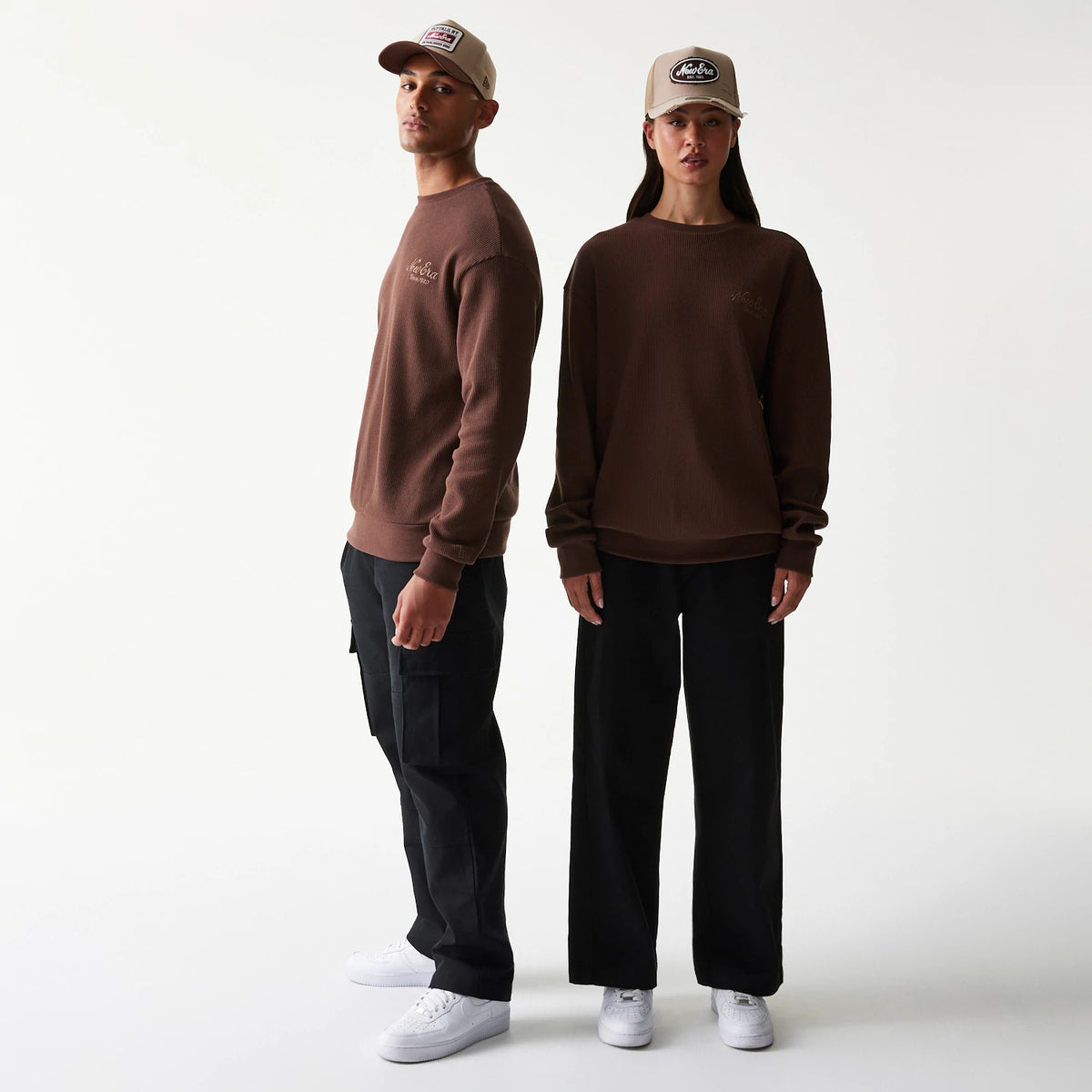 The model is wearing this New Era Script Waffle Crew Neck Sweater in brown. 1