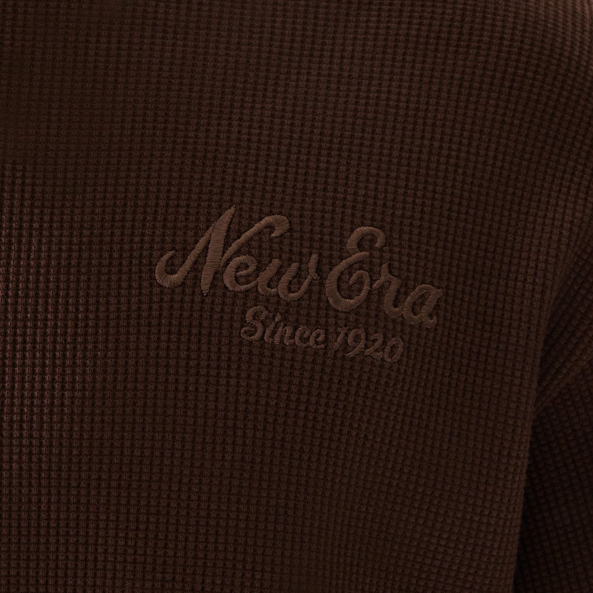 The model is wearing this New Era Script Waffle Crew Neck Sweater in brown. 6