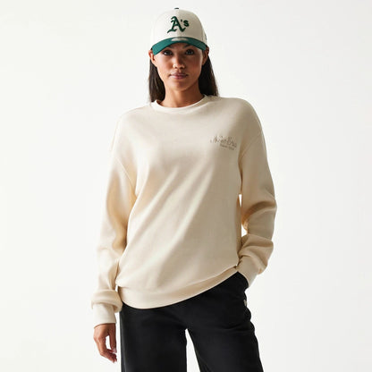 The model is wearing this New Era Script Waffle Crew Neck Sweater in light beige. 4
