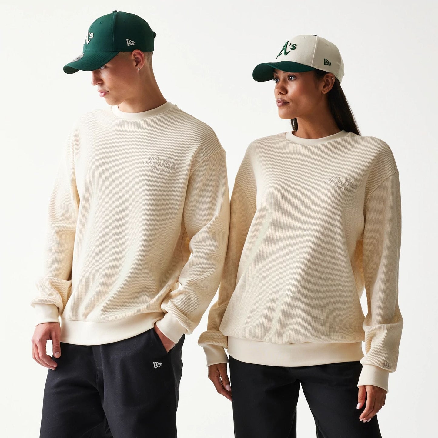 The model is wearing this New Era Script Waffle Crew Neck Sweater in light beige. 1