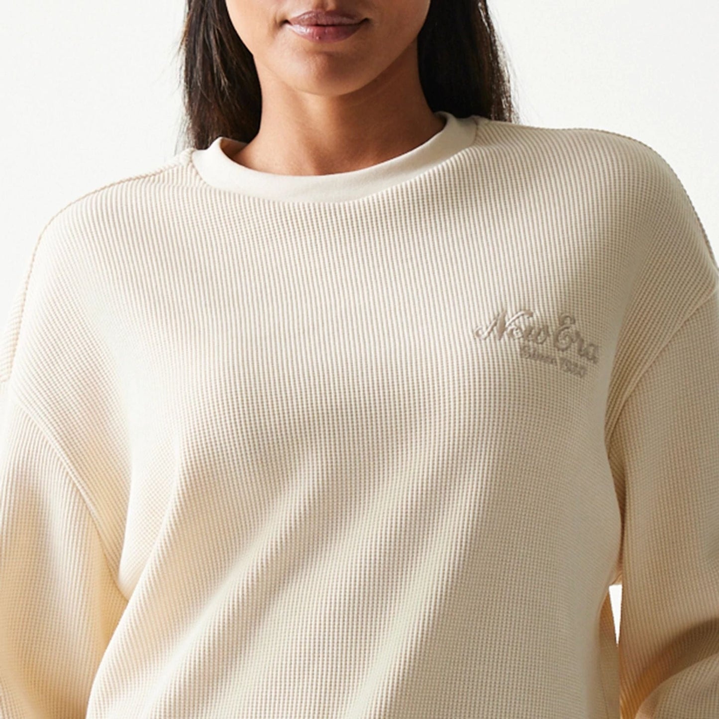 The model is wearing this New Era Script Waffle Crew Neck Sweater in light beige. 8