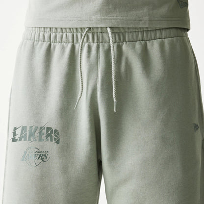 New Era LA Lakers NBA Pastel Green Shorts, front view showing a drawstring waistband and two printed Lakers logos on the left thigh with a small embroidered New Era logo above the hem on the right leg.