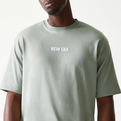 The model is wearing this New Era Graphic Oversized T-Shirt in pastel green. 5