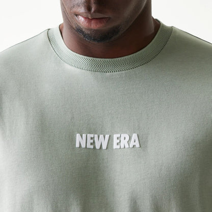 The model is wearing this New Era Graphic Oversized T-Shirt in pastel green. 6
