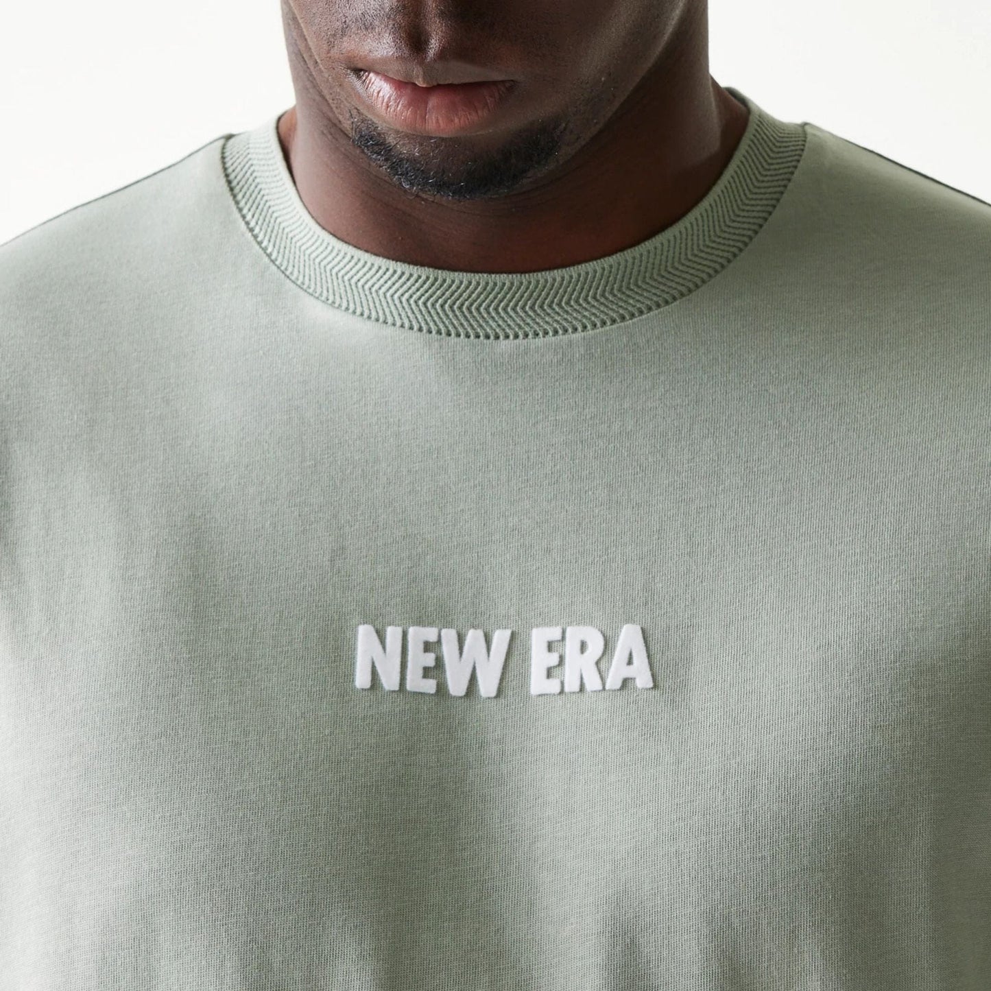 The model is wearing this New Era Graphic Oversized T-Shirt in pastel green. 6