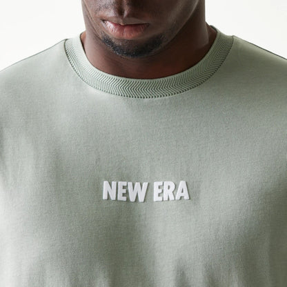 The model is wearing this New Era Graphic Oversized T-Shirt in pastel green. 6