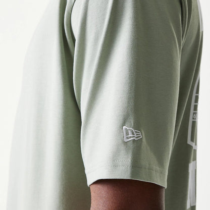 The model is wearing this New Era Graphic Oversized T-Shirt in pastel green. 7
