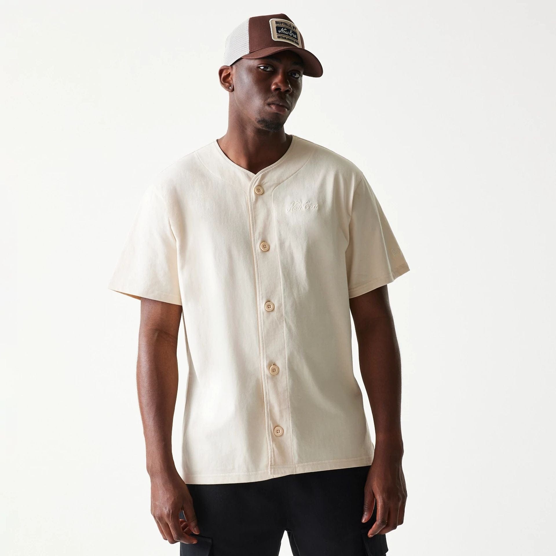 The model is wearing this New Era Script T-Shirt in light beige. 3
