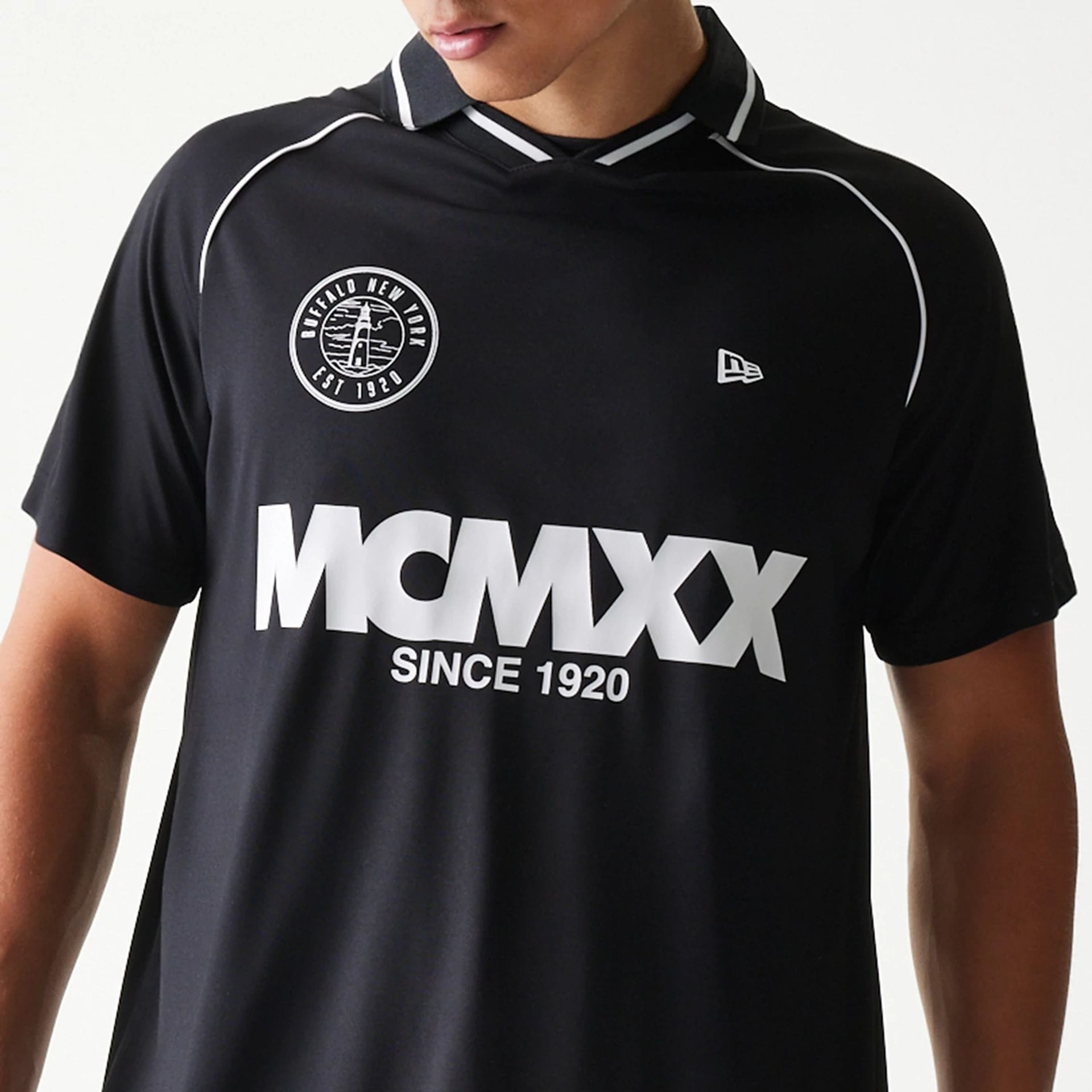 The model is wearing this New Era Football T-Shirt in black. 6