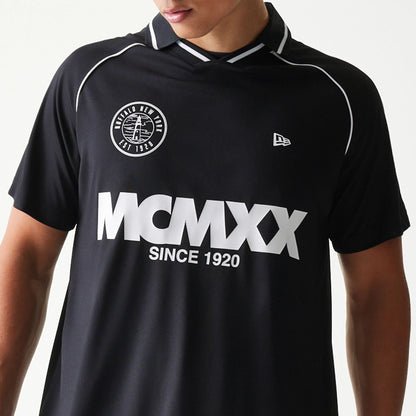 The model is wearing this New Era Football T-Shirt in black. 6