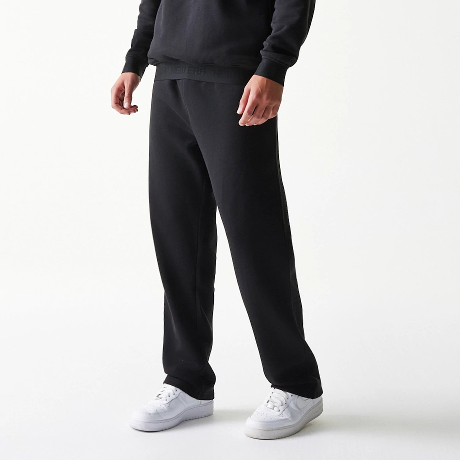 The model is wearing this New Era Tech Straight Leg Joggers in black on black. 3