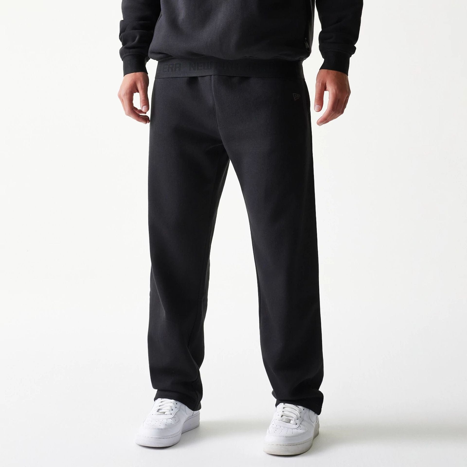 The model is wearing this New Era Tech Straight Leg Joggers in black. 1