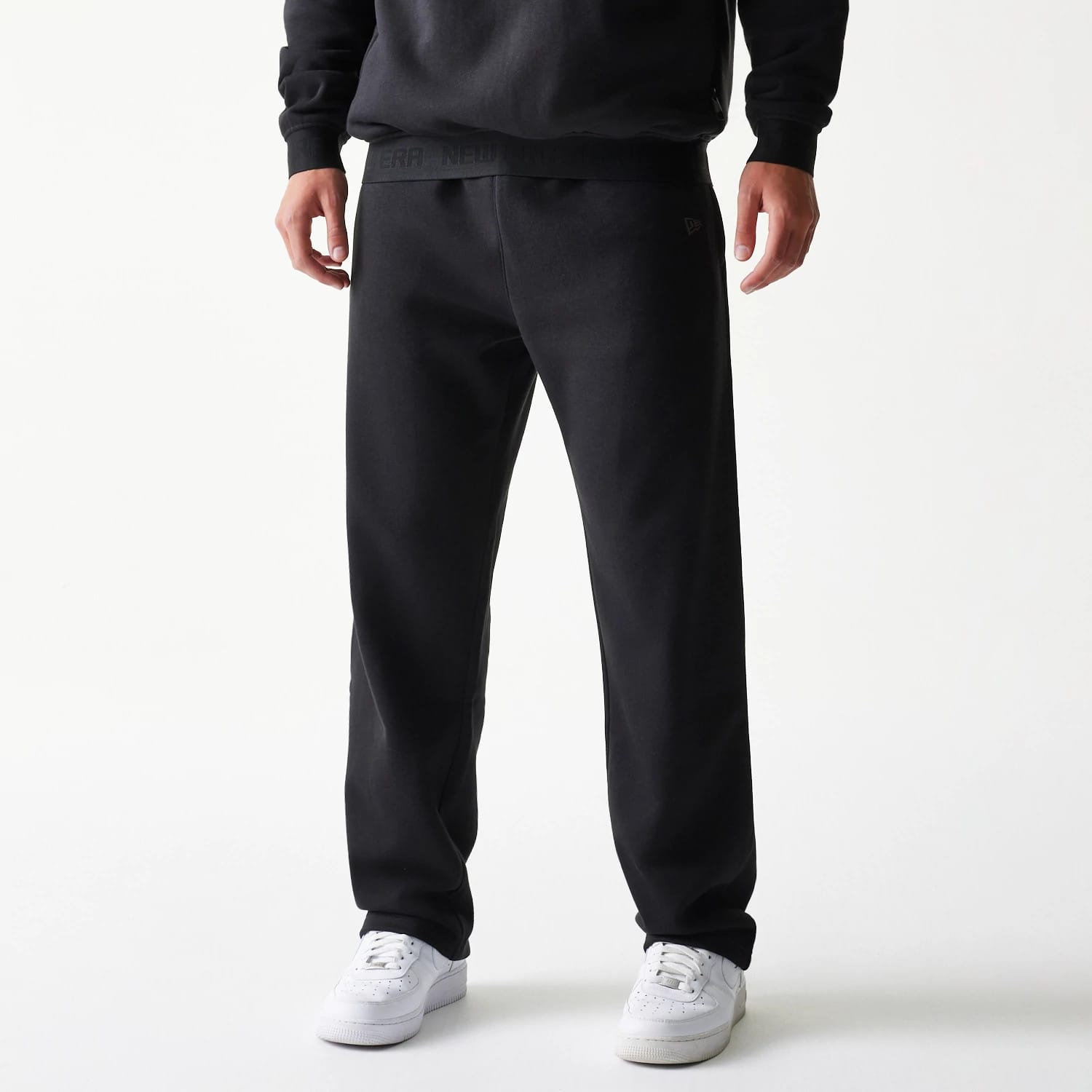 The model is wearing this New Era Tech Straight Leg Joggers in black on black. 1