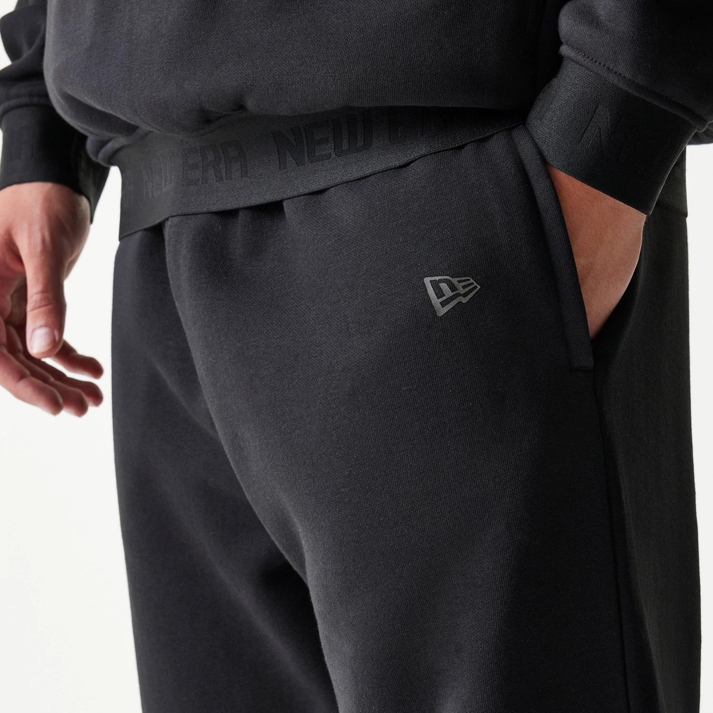 The model is wearing this New Era Tech Straight Leg Joggers in black on black. 5