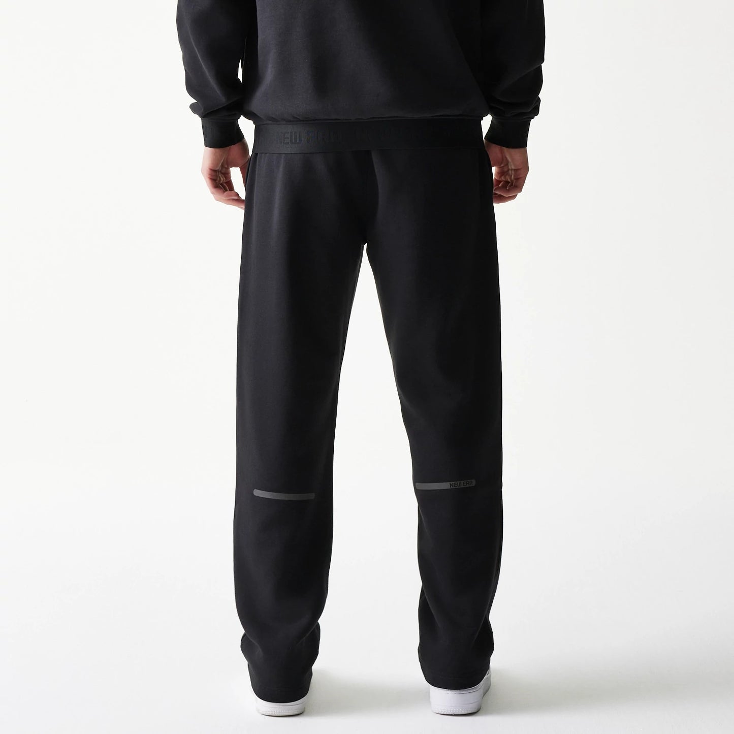 The model is wearing this New Era Tech Straight Leg Joggers in black on black. 2