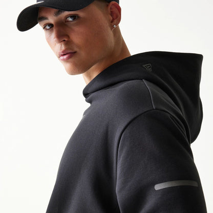The model is wearing this New Era Tech Oversized Pullover Hoodie in black. 5